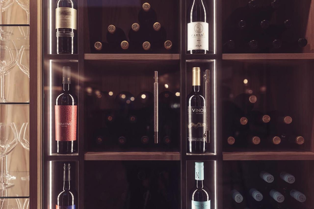 Longlands Inn & Cottages Карнфорт Экстерьер фото Wine bottles in a wine rack